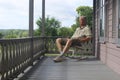 Man Sleeping Sitting on a Rocking Chair on a Porch Royalty Free Stock Photo