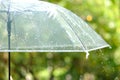 ItÃ¢â¬â¢s raining, Women walk in the rain. Hand of women holding an umbrella. She feel sad, Sky have a drizzling and overcast all the Royalty Free Stock Photo