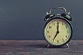 It`s seven o`clock already, time to wake up for breakfast, vintage old black metallic alarm clock Royalty Free Stock Photo