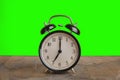 It`s seven o`clock already, time to wake up for breakfast, vintage old black metallic alarm clock Royalty Free Stock Photo