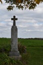 1800`s single cross gravestone in a country graveyard