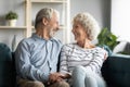 Grandfather and grandmother holding hands chatting laughing spend time together Royalty Free Stock Photo
