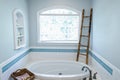 1950`s style bathroom with tile floor and dark brown cabinets in white and blue accents Royalty Free Stock Photo
