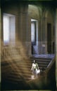 40s style woman on a staircase of a Castilian palace