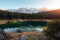 It`s sunset time. Autumn landscape with clear lake, fir forest and majestic mountains Royalty Free Stock Photo