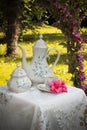 It`s tea time, afternoon in the garden with an elegant tea set framed by Mediterranean flowers Royalty Free Stock Photo