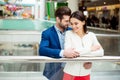 It`s time for fun. Cute cheerful successful happy lovely couple in elegant jacket standing near handrails and hugs at