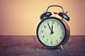 It`s twelve o`clock already, time to wake up for lunch, vintage old black metallic alarm clock Royalty Free Stock Photo