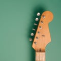 50s vintage electric guitar headstock on a pastel green background.