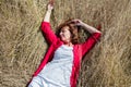 50s woman enjoying sun warmth sleeping peacefully on dry grass Royalty Free Stock Photo