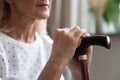 Closeup view walking stick and arms of disabled retired woman Royalty Free Stock Photo