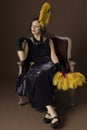 A 1920s woman wearing an evening dress with a gold headband and feathers Royalty Free Stock Photo