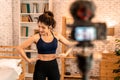 20s young Asian woman in sportswear doing talking to camera and explaining fitness tutorials online. Healthy girl