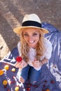 20s young blonde woman at picnic eating strawberry