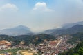 Sa Pa landscape with city, mountains, fog and trees the view from above from Sam Bay Cloud Yard in summer at Ham Rong Mountain. Royalty Free Stock Photo