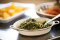 saag aloo in a buffet setting with serving spoon Royalty Free Stock Photo