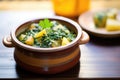 saag aloo in a ceramic pot on a wooden table Royalty Free Stock Photo