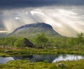 Saana fell and trekker`s hut seen from Lake Tsahkal Royalty Free Stock Photo