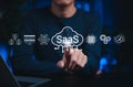 SaaS cloud computing and software service technology. Person interacts with SaaS cloud icons, represent Software as a Service, Royalty Free Stock Photo