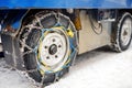 SAAS FE, SWITZERLAND - FEBRUARY 4, 2020: Chains on the wheel of official car in mountain resort Saas Fe during snow storm