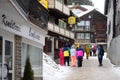 Saas Fee, Switzerland - February 4, 2020:Group of teenager tourists walking on street of mountain resort town in Switzerland,