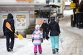 Saas Fee, Switzerland - February 4, 2020: Tourists walking on street of mountain resort town in Switzerland, Europe. Winter family