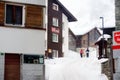 Saas Fee, Switzerland - February 4, 2020: Tourists walking on street of mountain resort town in Switzerland, Europe. Winter