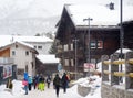 Saas Fee, Switzerland - February 4, 2020: Tourists walking on street of mountain resort town in Switzerland, Europe. Winter