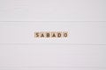 Sabado week day name on white wooden background Royalty Free Stock Photo