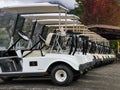 Outdoor scenery during day time with a row of golf carts. Royalty Free Stock Photo