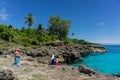 Asian hijab girsl standing on the rock and takes photo at Ujung Karang beach in Sabang island, Indonesia. Traveling concept Royalty Free Stock Photo