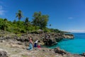 Asian hijab girsl standing on the rock and takes photo at Ujung Karang beach in Sabang island, Indonesia. Traveling concept Royalty Free Stock Photo