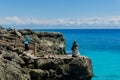 Asian hijab girsl standing on the rock and takes photo at Ujung Karang beach in Sabang island, Indonesia. Traveling concept