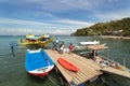 Sabang, Puerto Galera, Philippines - January 13, 2017: Seascape of pier sea, blue sky, palms and boats. popular tourist and diving Royalty Free Stock Photo