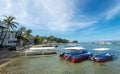 Sabang, Puerto Galera, Philippines - January 13, 2017: Seascape of pier sea, blue sky, palms and boats. popular tourist and diving Royalty Free Stock Photo