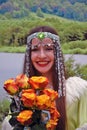 Sabantui celebration in Moscow. Woman in traditional clothes greets visitors.