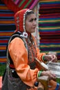 Sabantui celebration in Moscow. Woman in traditional clothes shows crafts