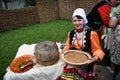 Sabantui celebration in Moscow. Woman in traditional clothes shows crafts