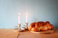 Sabbath image. challah bread and candelas on wooden table