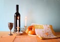 Sabbath image. challah bread and candelas on wooden table