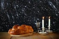Sabbath image. challah bread and candelas on wooden table. glitter overlay Royalty Free Stock Photo