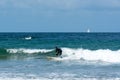 A young athletic boy surfing waves in the Atlantic on the coast of Brittany on a summer day Royalty Free Stock Photo