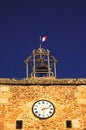 Sablet bell and clock tower with french flag in wind Royalty Free Stock Photo