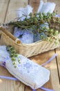 Sachet with ukrainian embroidery, sheaf of wheat and dried herbs on wooden background Royalty Free Stock Photo