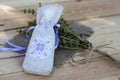 Sachet with ukrainian embroidery, sheaf of wheat and dried herbs on wooden background Royalty Free Stock Photo