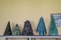 Sachkhere Region Georgia - A row of New Years Trees sitting on a utility table in a village school