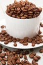 Coffee beans spilling out of a cup Royalty Free Stock Photo