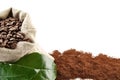 Sack full of coffee beans with green leaf backdrop Royalty Free Stock Photo