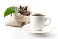 Sack full of coffee beans with green leaf and coffee cup Royalty Free Stock Photo