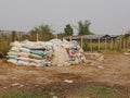 Sacks / bags of dairy co`s dry manure being stacked up, ready to be sold and used as organic fertilizer Royalty Free Stock Photo